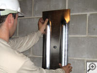 Mounting a foundation wall plate for an earth anchor installation in Lockport.