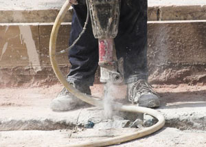 Jackhammering a slab floor in a St Andrews home.