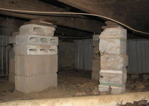 crawl space repairs done with concrete cinder blocks and wood shims in a Mitchell home