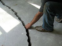 a severely damaged cracked concrete slab floor in Oakbank