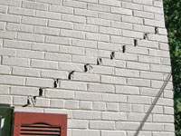 Stair-step cracks showing in a home foundation in La Salle