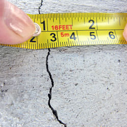 A crack in a poured concrete wall that's showing a normal crack during curing in St Adolphe