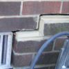 A closeup of a failed tuckpointing job where the brick cracked on a Mulvihill home.