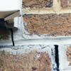 Failed crack repair showing old tuckpointing that cracked on a Portage La Prairie home.