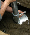 Selkirk helical pier installation nearing completion, with the blade being advanced into the foundation soils.