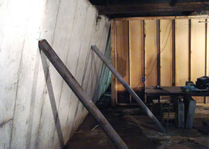 A severely tilting foundation wall propped up by steel beams in Mulvihill.