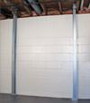 A steel i-beam system installed on a Mulvihill foundation wall