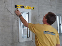 Positioning a wall plate cover on a foundation wall in Thompson.