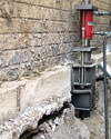 A completed installation of foundation push piers lifting a foundation in Ste Anne
