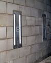 an inside view of foundation wall anchors installed along a basement wall to brace and repair the structure in Springfield