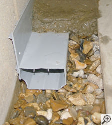 A no-clog basement french drain system installed in St Andrews